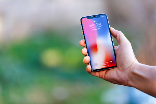 Çanakkale, Turkey- November 28,2017 Outdoor shot of a New IPhone X Silver Home Screen with man hand.